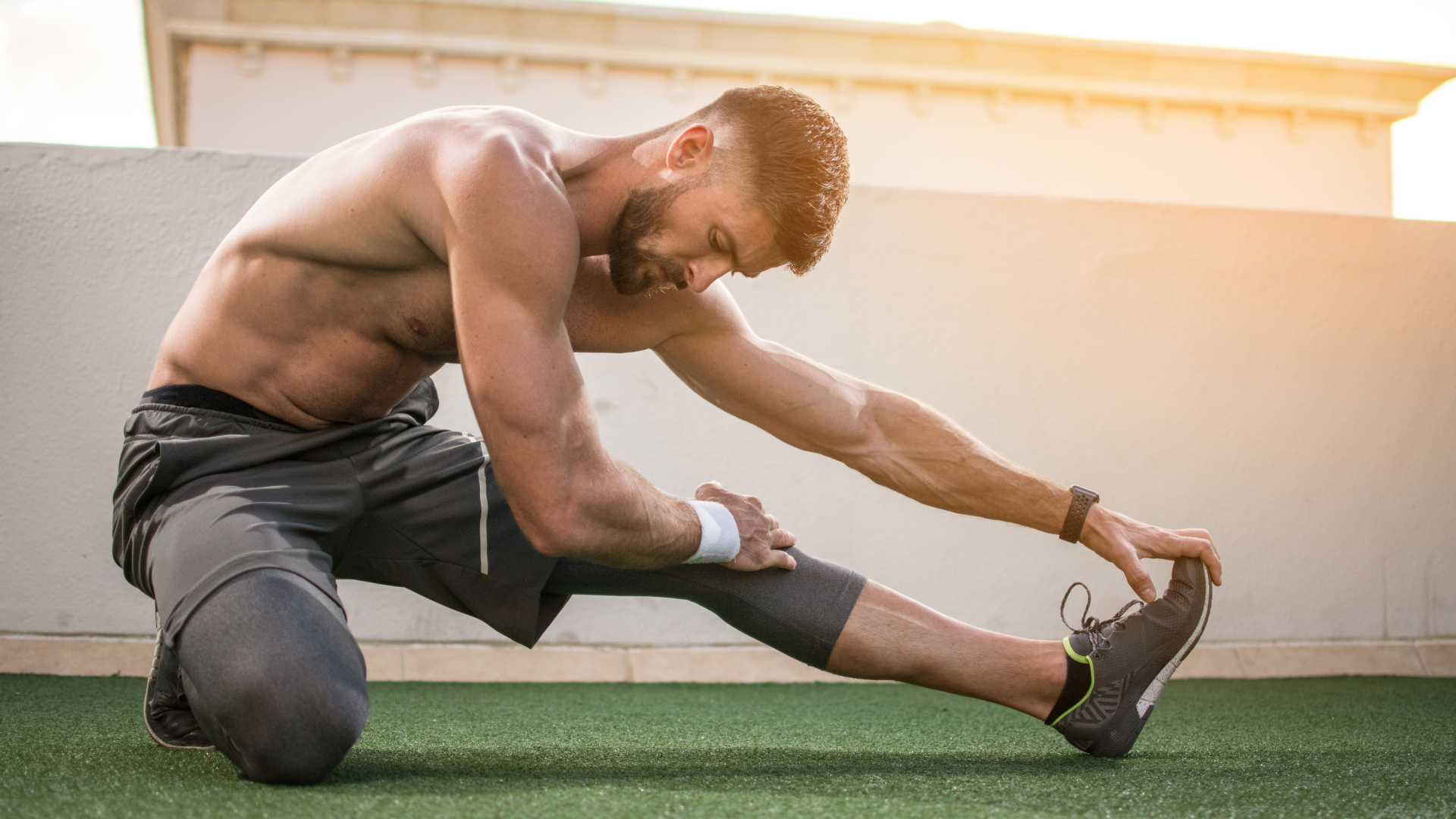 Man doing post-workout recovery stretches